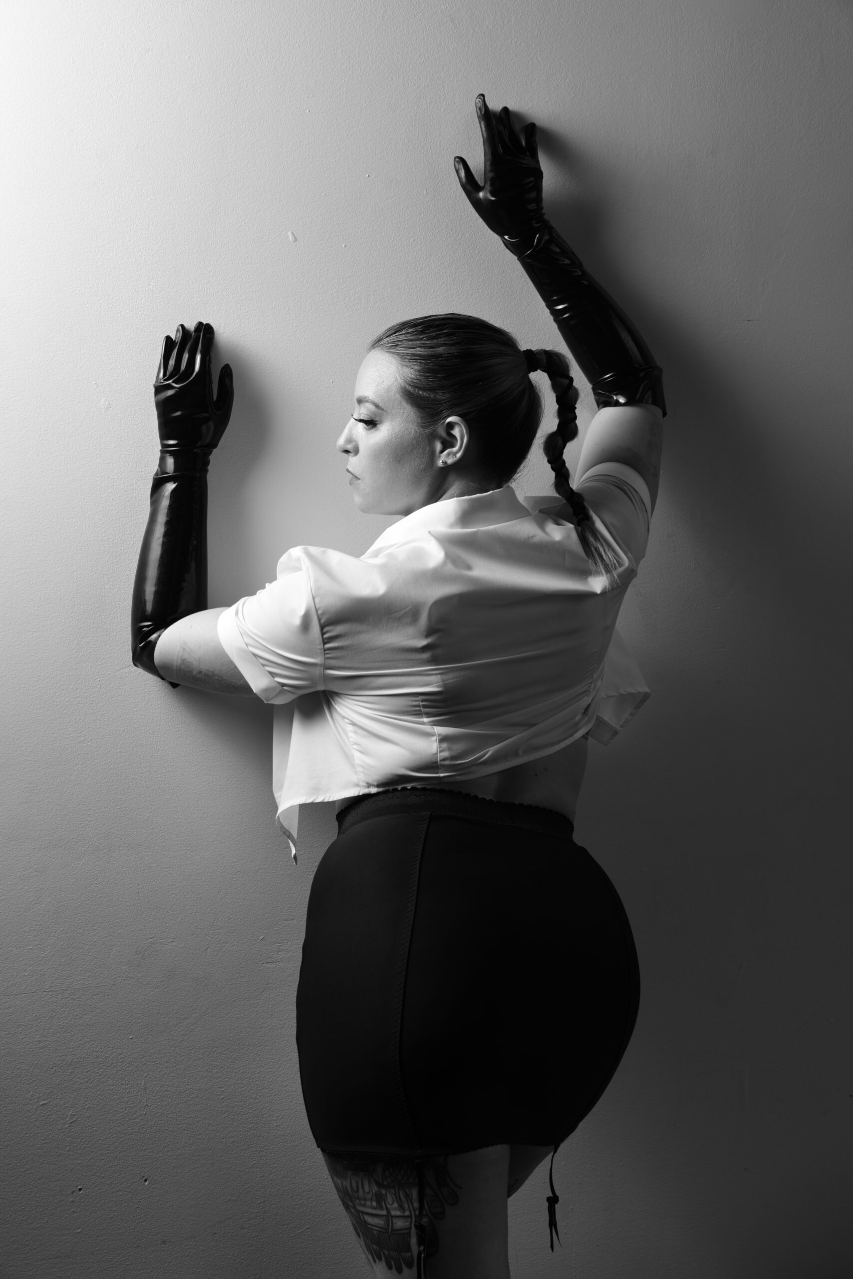Louise Fatale in a white shirt and black gloves